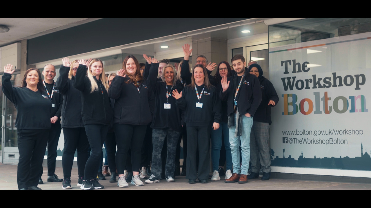 Picture of the workshop staff stood outside the workshop office